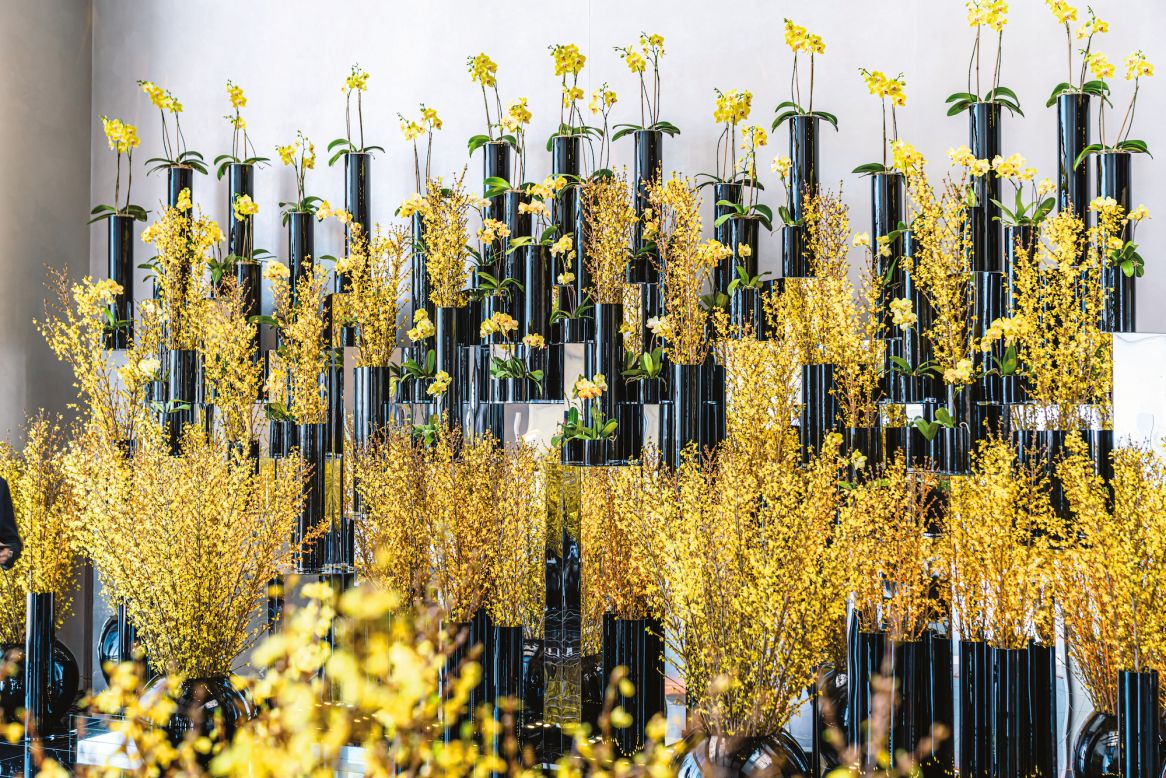 Forsythia branches and phalaenopsis orchids arranged in the lobby of the Four Seasons Philadelphia.