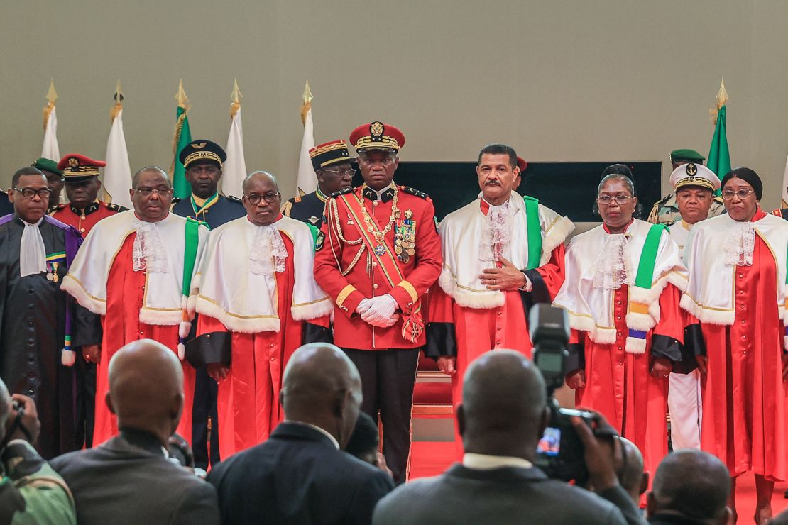 Gen. Brice Nguema (center) looks on during his swearing-in ceremony.