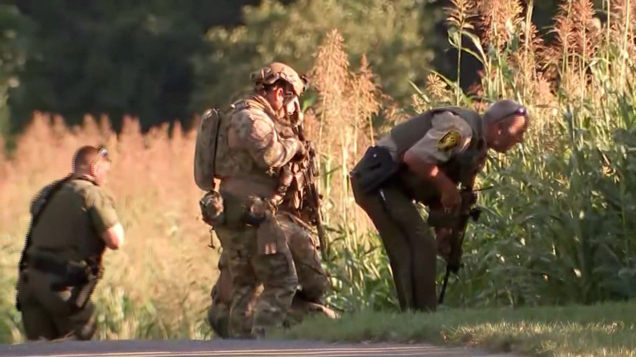 Law enforcement officials search for Danelo Cavalcante on August 31 in West Chester, Pennsylvania.