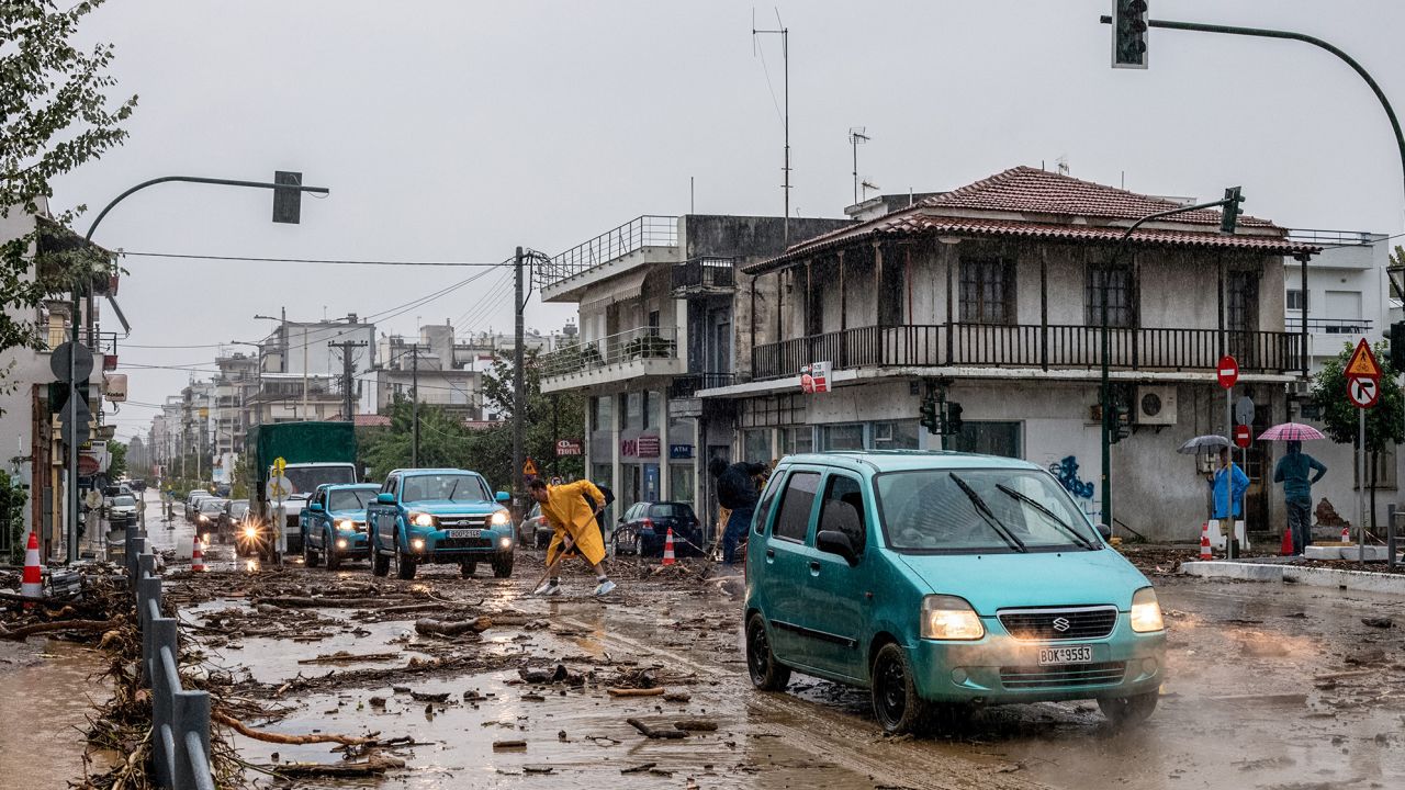 Cars drive among debris and mud, following a flash flood during a storm in the city of Volos, Greece, September 5, 2023. 