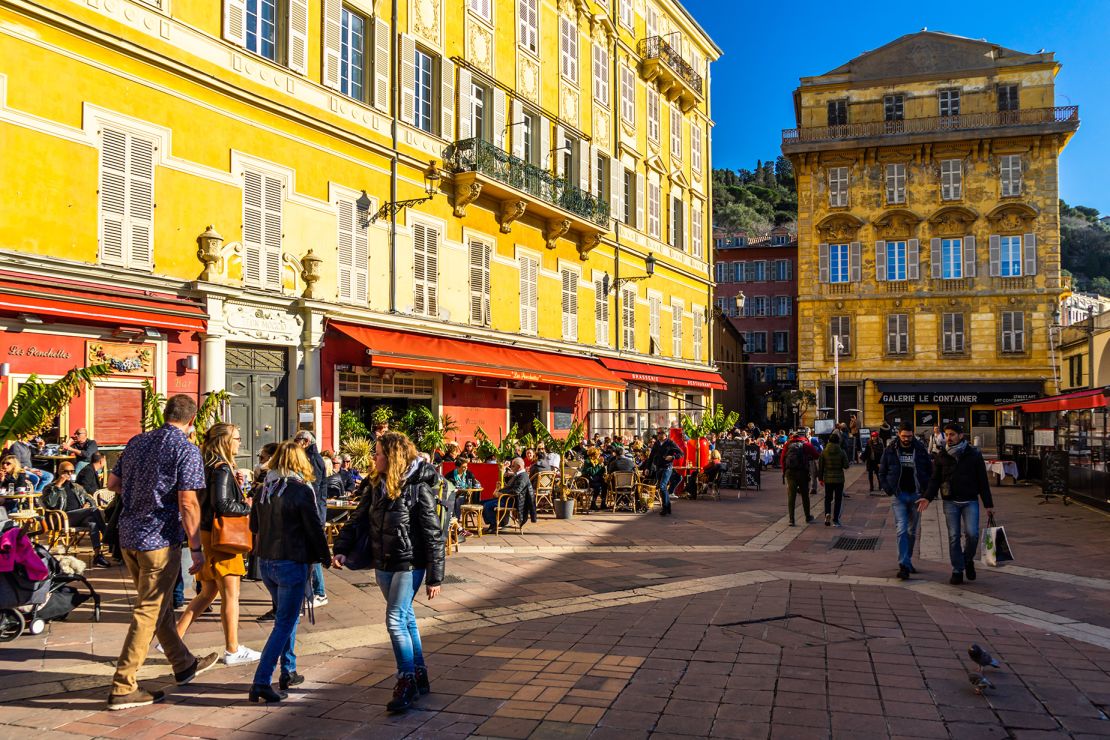 Tourists and locals strolling in Cours Saleya, a lively area of Nice full of bars and restaurants. Nice, France, January 2020
