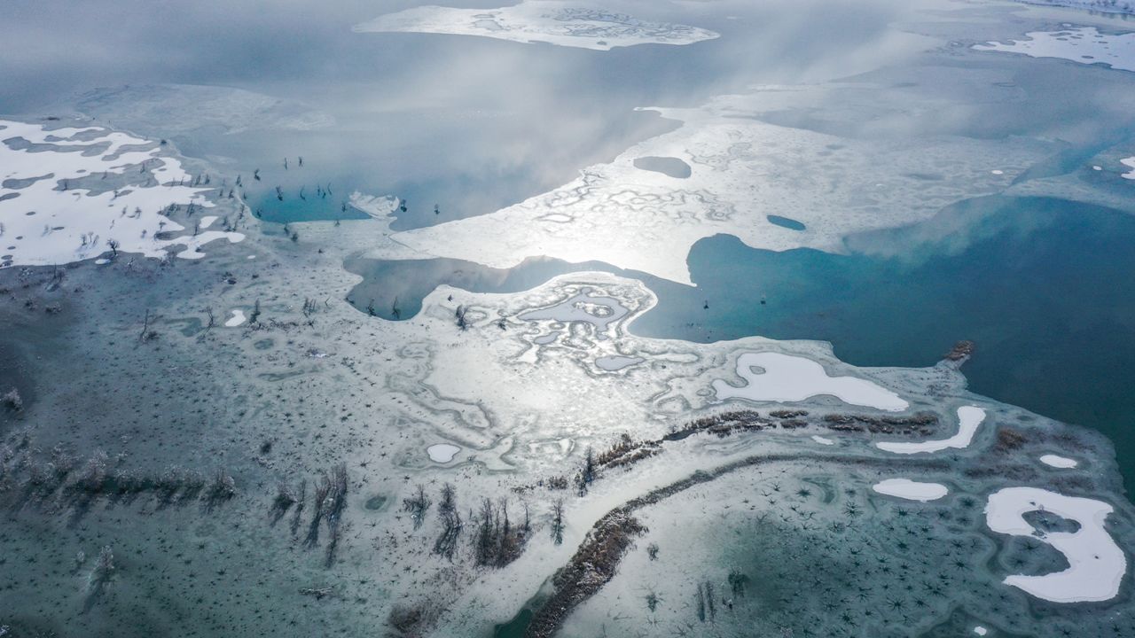 Aerial view of snow covering on Lop Nur lake and Taklamakan Desert at Yuli County on November 28, 2021, in Bayingolin Mongol Autonomous Prefecture, Xinjiang Uygur Autonomous Region of China.