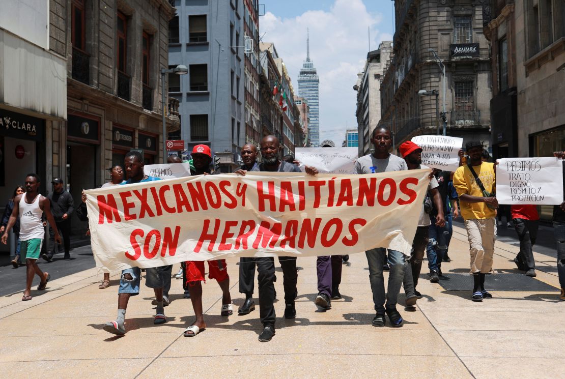 Migrants, mostly from Haiti, take part in a protest with a banner that reads "Mexicans and Haitians are brothers" in Mexico City, Mexico May 29, 2023. 