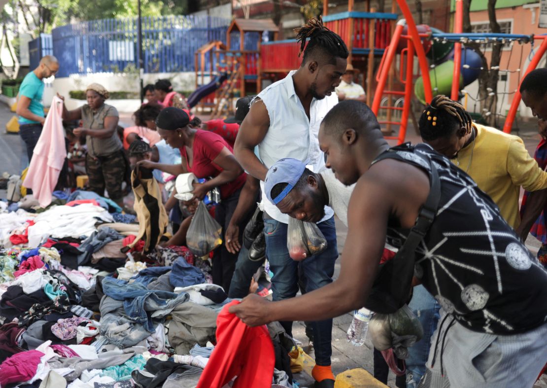 Migrants, mostly from Haiti, collect clothes donated by a group of volunteers, at the Giordano Bruno in Mexico City, Mexico, April 6, 2023. 