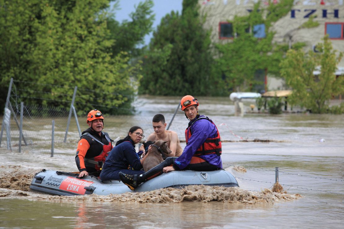 People and dogs are rescued by firefighters from floods in the city of Larissa, Greece, September 6, 2023.