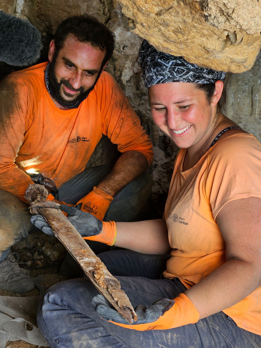 Archaeologists Oriya Amichay (right) and Hagay Hamer (left) with one of the swords.