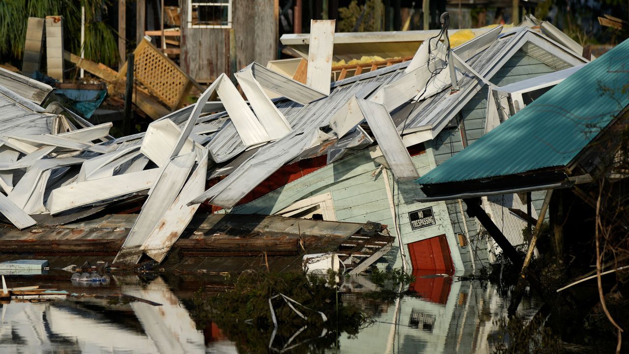 FILE - An unstilted home which came off its blocks sits partially submerged in a canal, in Horseshoe Beach, Fla., Friday, Sept. 1, 2023, two days after the passage of Hurricane Idalia. (AP Photo/Rebecca Blackwell, File)