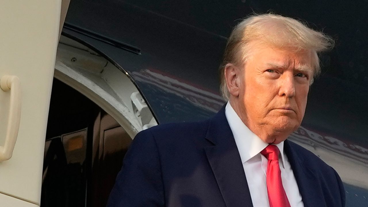 Former President Donald Trump steps off his plane as he arrives at Hartsfield-Jackson Atlanta International Airport on Thursday, August 24.