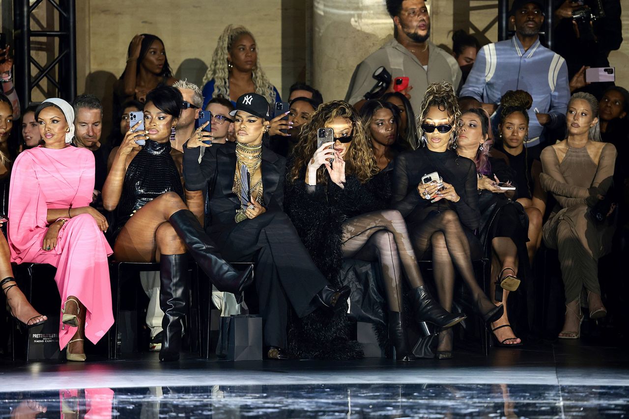 From left: Halima Aden, Coco Jones, Teyana Taylor, Winnie Harlow, and La La Anthony sit front row at the PrettyLittleThing x Naomi Campbell runway show.