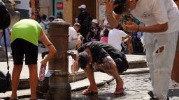 People refresh themselves with water near the Pantheon in Rome, Italy, on Aug. 22, 2023. Italy is in the grip of its third major heatwave of this summer, as the hottest two-year period on record continues in the country. (Photo by Jin Mamengni/Xinhua via Getty Images)