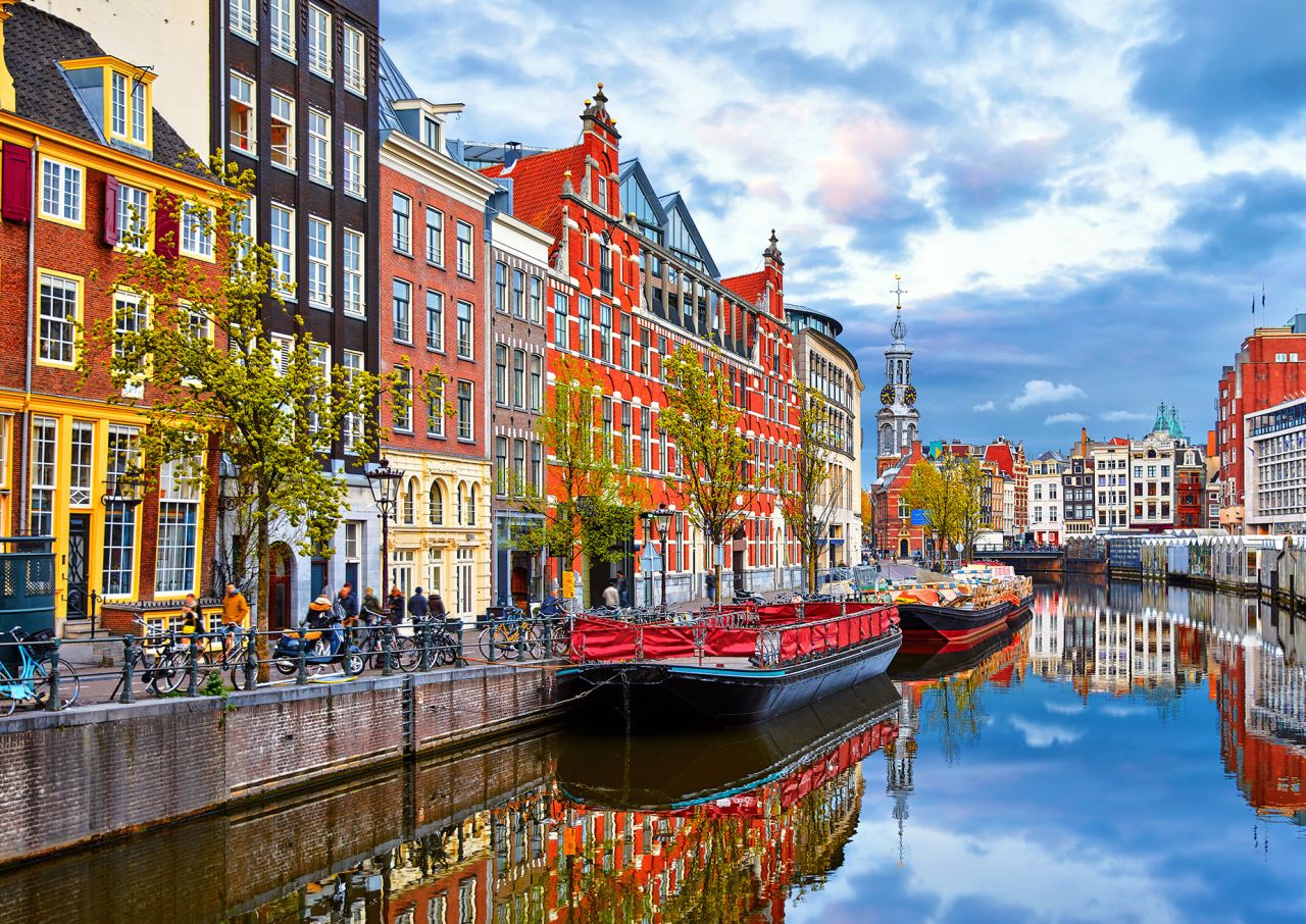 Channel in Amsterdam Netherlands houses river Amstel landmark old european city spring landscape.