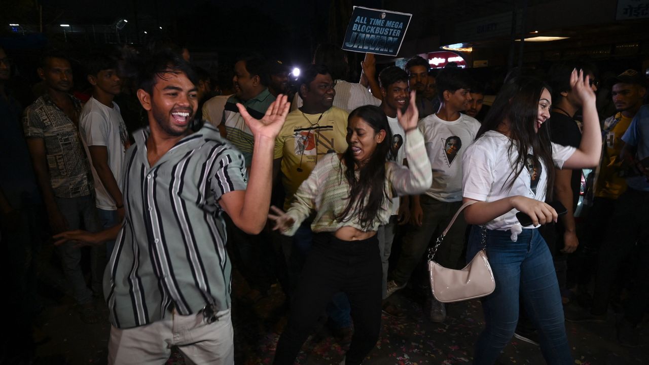 Shah Rukh Khan fans dance outside a movie theater in Mumbai on September 7, 2023.