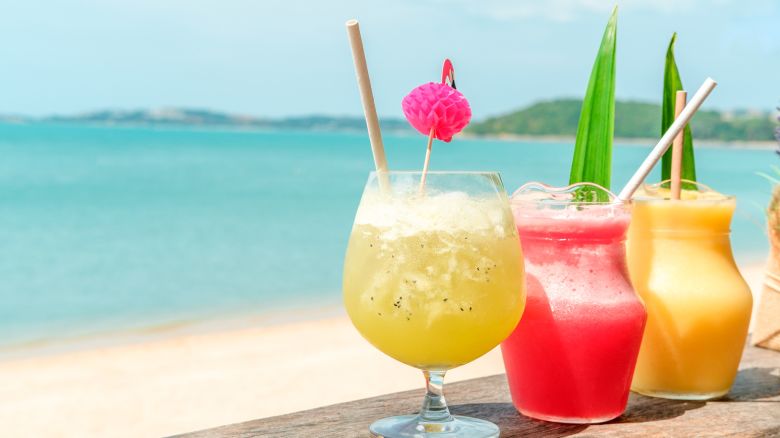 Colorful mocktails at the beach bar with sea background. Vacation, get away, summer outing concept