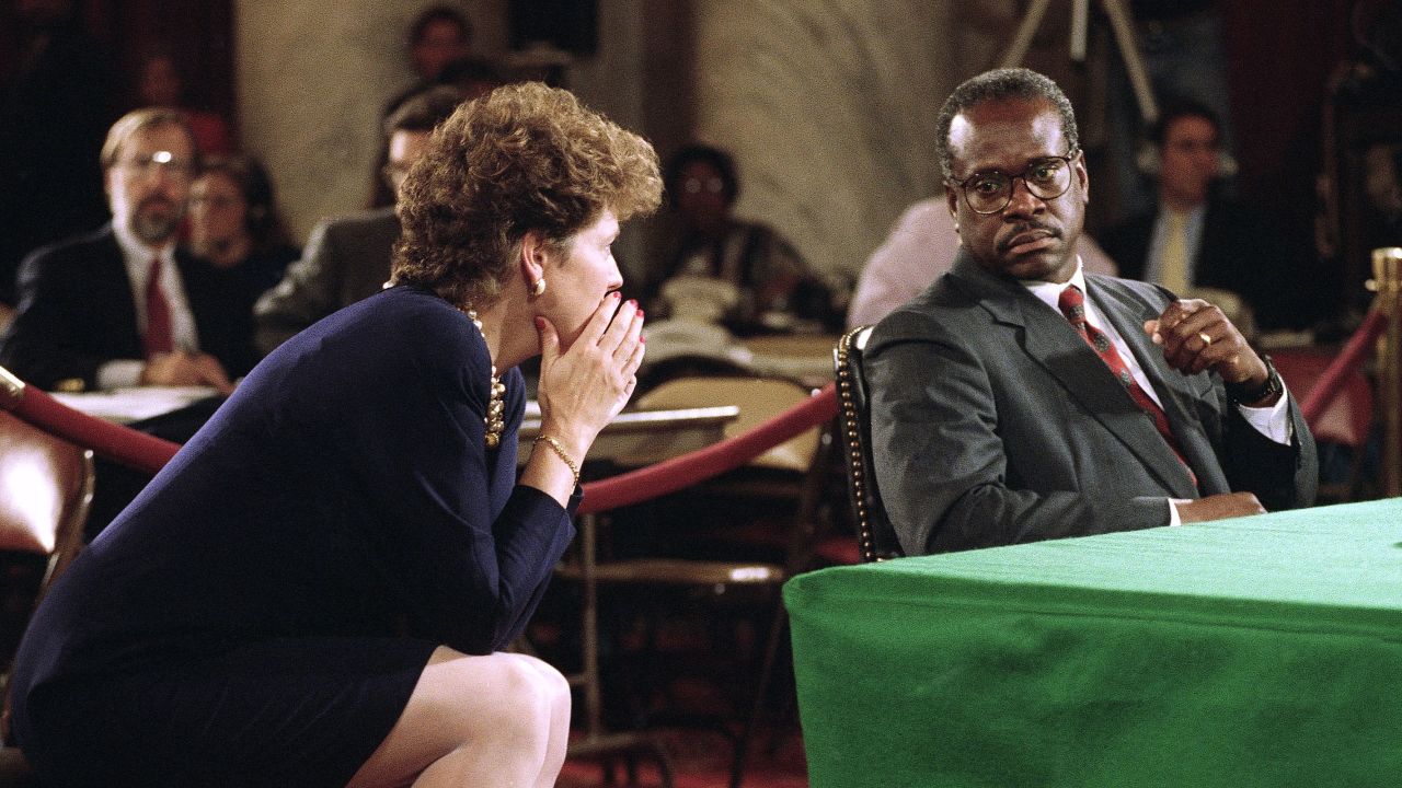 Judge Clarence Thomas listens to his wife Virginia during a break in hearings before the Senate Judiciary Committee on Capitol Hill in Washington, DC, on October 12, 1991.