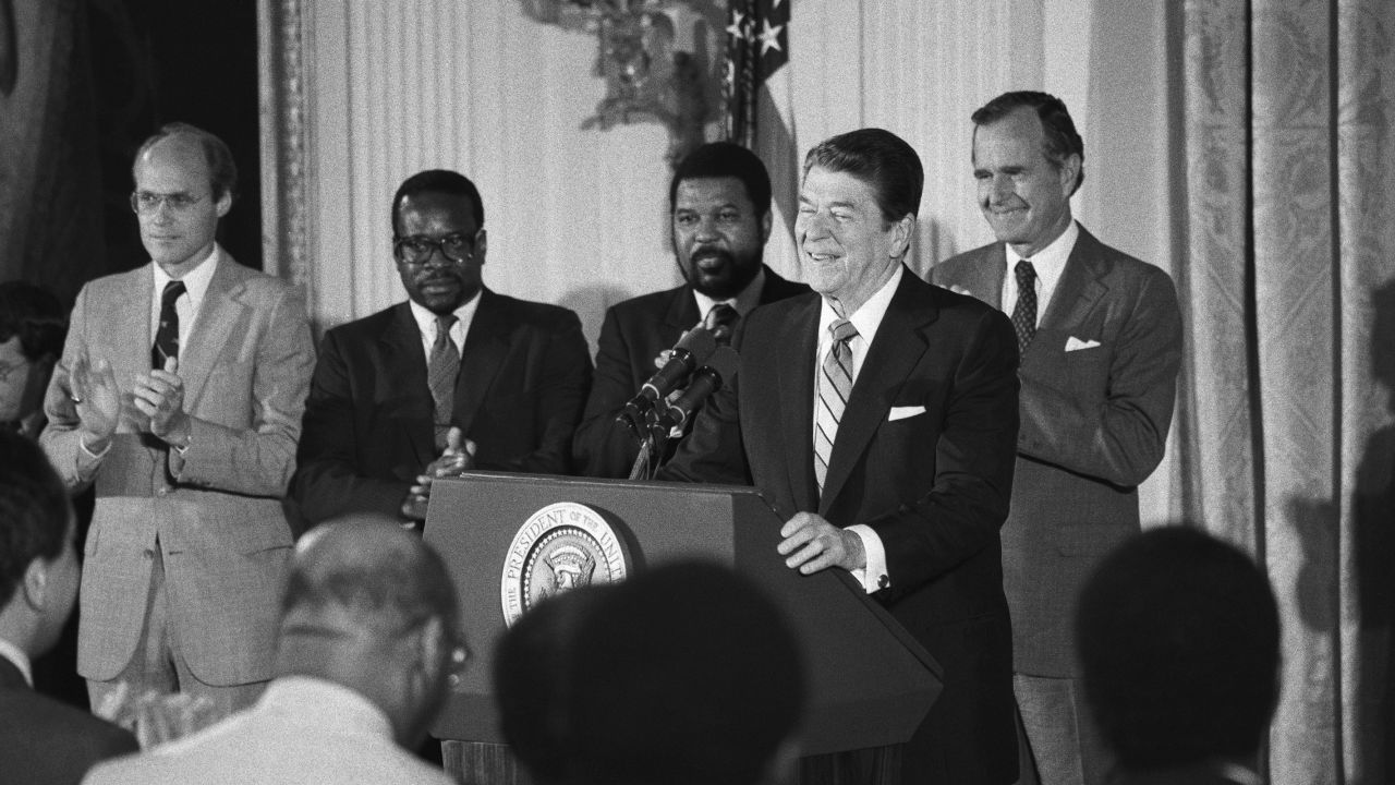 Thomas, second from left, stands with Reagan as the President addressed black appointees at the White House in 1984.