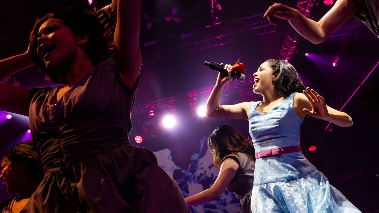 Arielle Jacobs (Imelda Marcos -- blue dress) sings in "Here Lies Love."