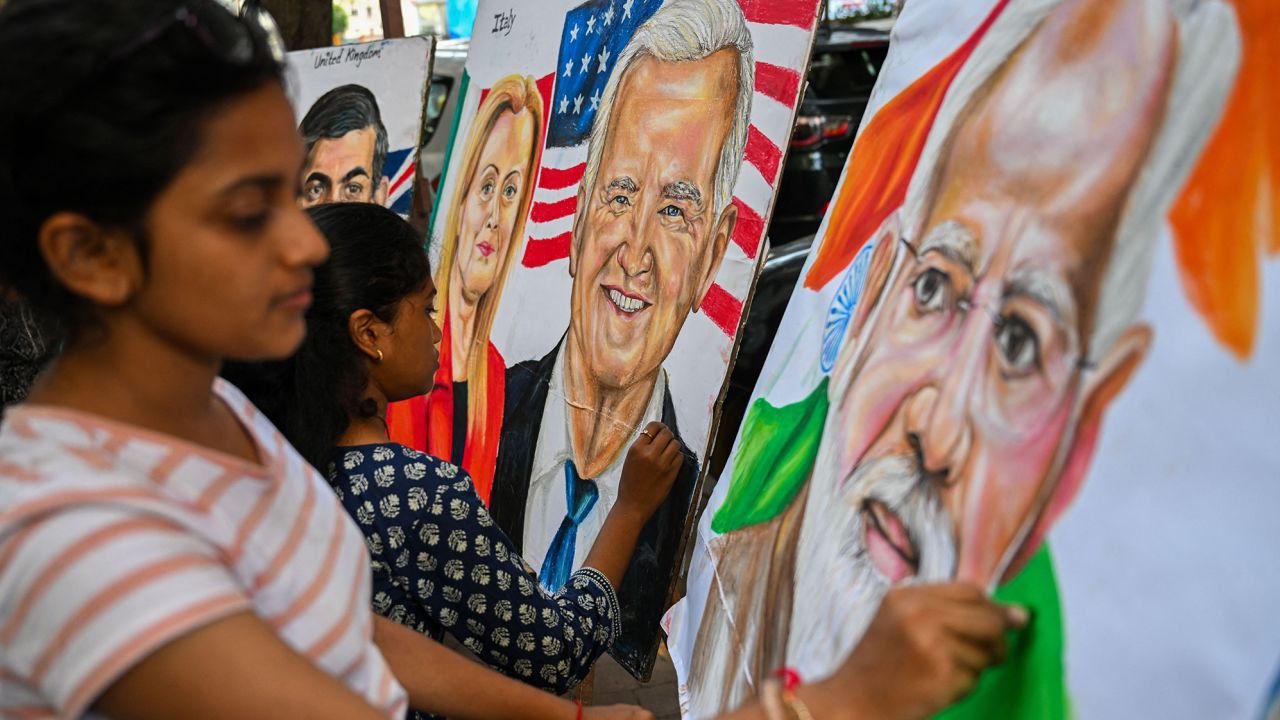 Students give final touches to paintings of US President Joe Biden, Indian Prime Minister Narendra Modi and Italian Prime Minister Giorgia Meloni at an art school in Mumbai on September 5, 2023