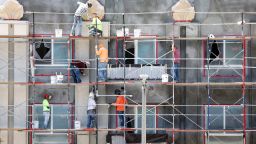 LOS ANGELES, CALIFORNIA - JULY 12: Construction workers stand on scaffolding while building residential housing on July 12, 2023 in Los Angeles, California. According to the Bureau of Labor Statistics, the U.S. economy added 209,000 jobs in June in a sign of a slowing economy amid the Federal Reserve's inflation-fighting campaign. (Photo by Mario Tama/Getty Images)