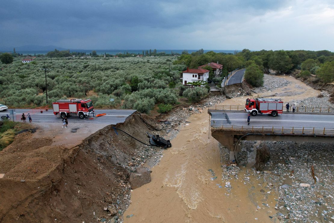 Firefighting crews are seen on a collapsed bridge in the village of Kala Nera, in central Greece, September 7 2023.