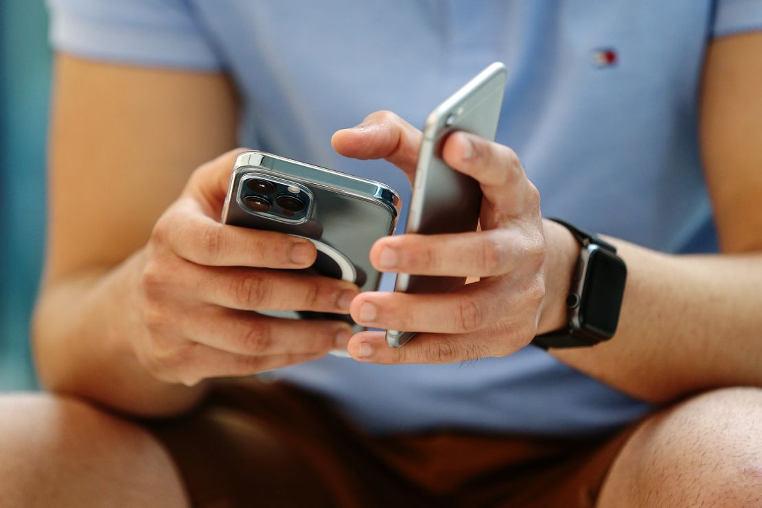 A customer tries out an iPhone 12 Pro Max at the Apple flagship store during a product launch event in Sydney, Australia, on November 13, 2020. 