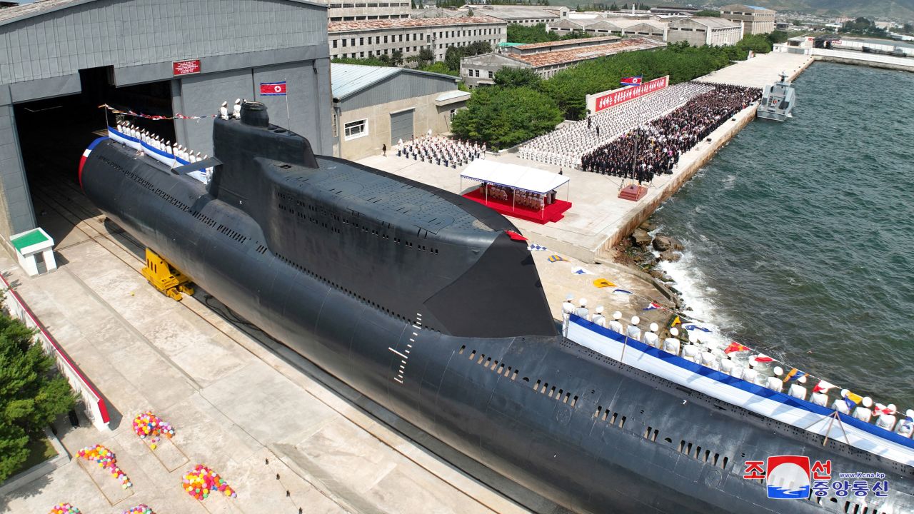 People attend what North Korean state media said was a launch ceremony for a new tactical nuclear attack submarine, in a handout image released on September 8, 2023.  