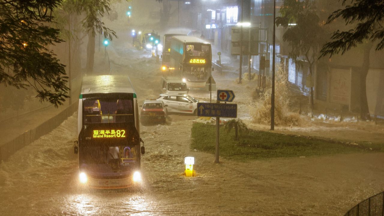 A bus drives through a flooded area in Hong Kong on September 8, 2023.