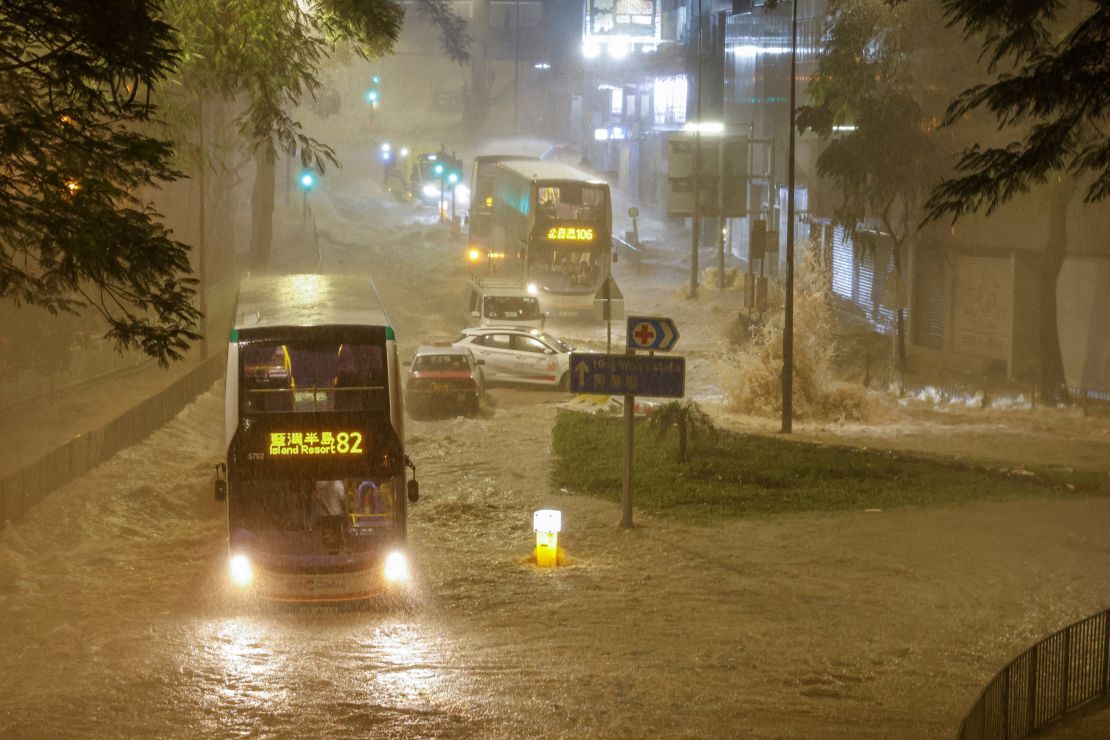 A bus drives through a flooded area in Hong Kong on September 8, 2023.