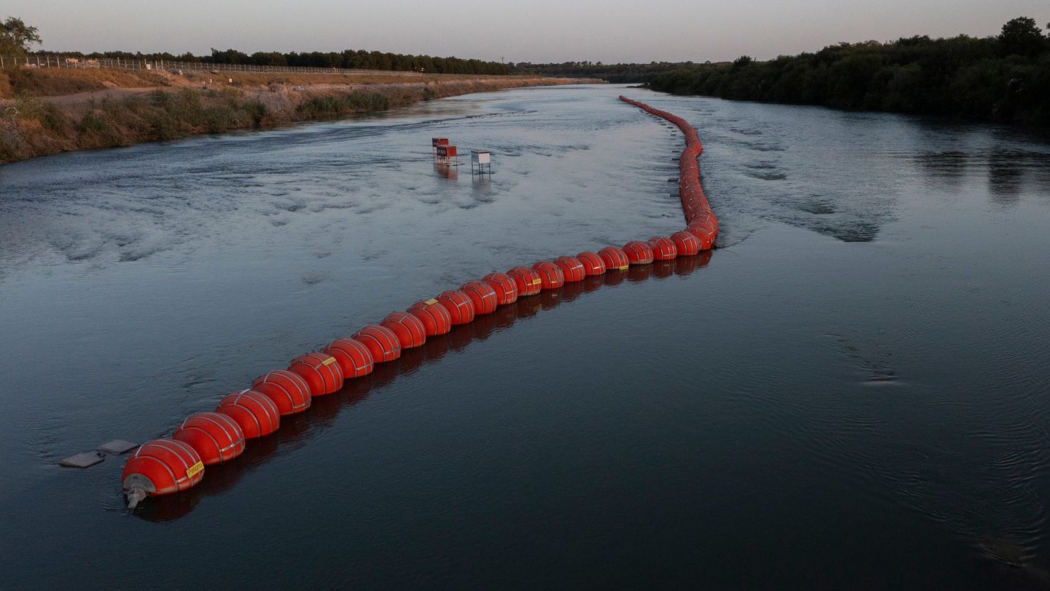 Buoys placed by the state of Texas float on the Rio Grande international boundary between Mexico and the US in Eagle Pass, Texas, on July 21, 2023.