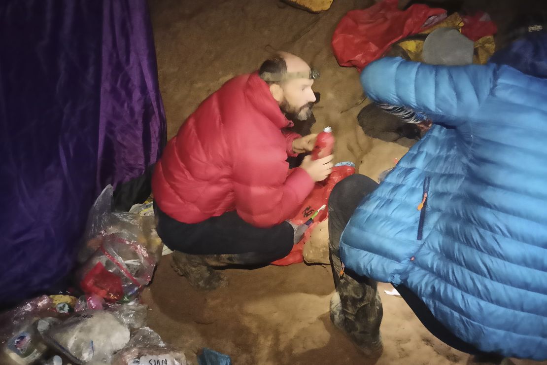 American caver Mark Dickey, left, 40, talks to a colleague inside the Morca cave near Anamur, southern Turkey, on Sept. 7, 2023.