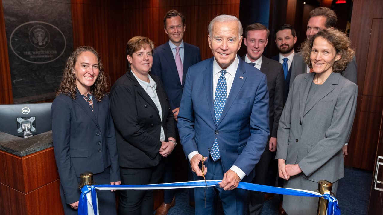 U.S. President Joe Biden is seen cutting the ribbon to open the newly renovated White House Situation Room in a White House handout photo, as he stands with White House and National Security Council staff including National Security Advisor Jake Sullivan in the West Wing of the White House in Washington, DC. Source: The White House