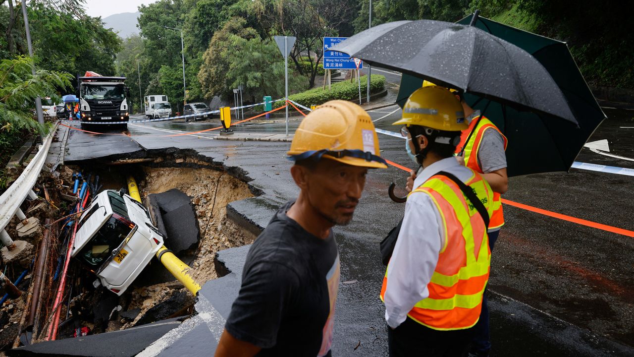 A vehicle in a collapsed road section after flood and heavy rains, in Hong Kong, China, September 8, 2023.