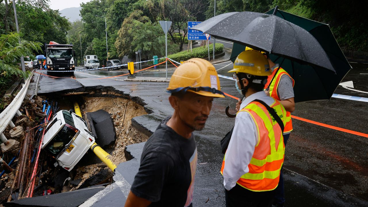 A vehicle in a collapsed road section after flood and heavy rains, in Hong Kong, China, September 8, 2023. 