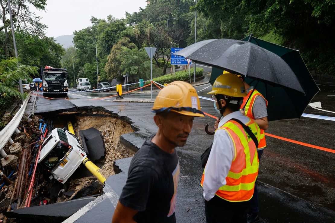A vehicle in a collapsed road section after flood and heavy rains, in Hong Kong, China, September 8, 2023. 