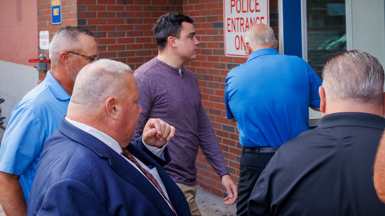 Philadelphia Police Officer Mark Dial, center, enters the 1st District Police station in Philadelphia, on Friday, September 8, 2023.