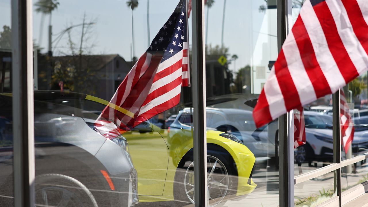 American flags fly near new Chevrolets displayed for sale in a Chevrolet dealership on February 15, 2023 in Glendale, California.