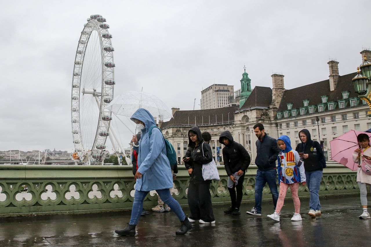 People brave the rain on Westminster Bridge in London, Britain, on Aug. 2, 2023. A yellow alert for storms stretching from London to Manchester and covering much of the Midlands and Wales was issued by the Met Office on Wednesday. (Photo by Xinhua via Getty Images)
