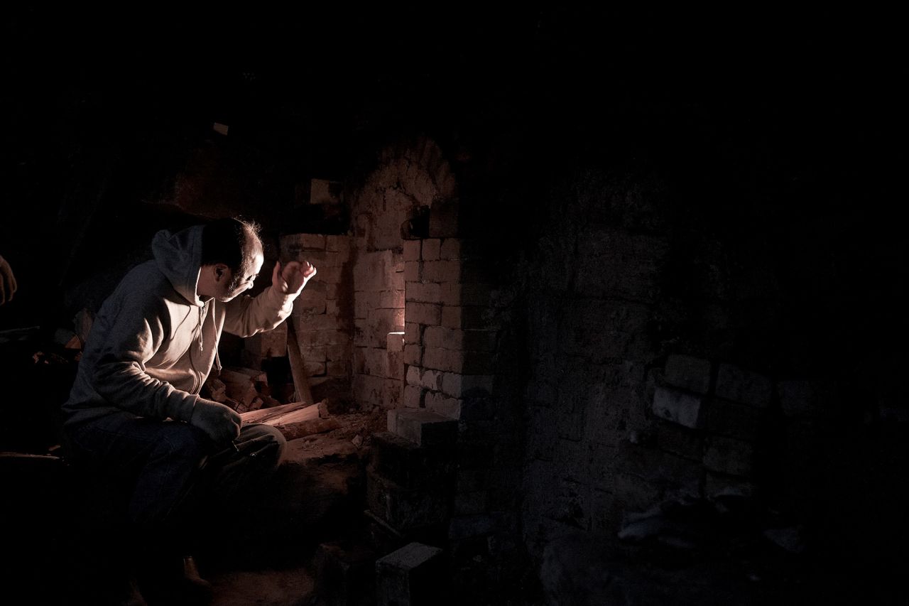 Kwon Dae Sup checks on the pots firing in his kiln. The self-built furnace is made of two chambers, which can only fit four jars. Kwon only uses pine wood for the fire, which can reach over 1250 degrees Celcius (2282 degrees Fahrenheit).