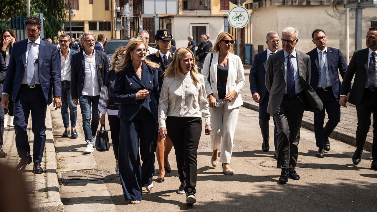 Giorgia Meloni, center, walks in Caivano on August 31, 2023. Her visit was prompted by concerns over drug use and crime in the town, including the alleged rape of two girls by a group of boys.