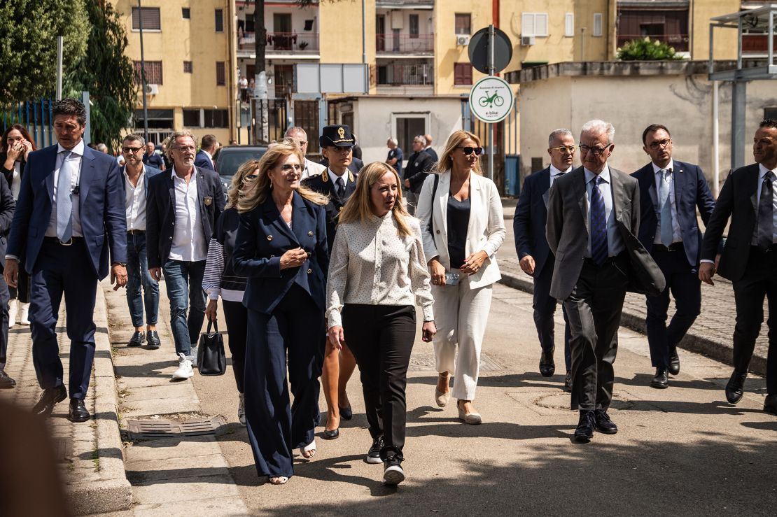 Giorgia Meloni, center, walks in Caivano on August 31, 2023. Her visit was prompted by concerns over drug use and crime in the town, including the alleged rape of two girls by a group of boys.