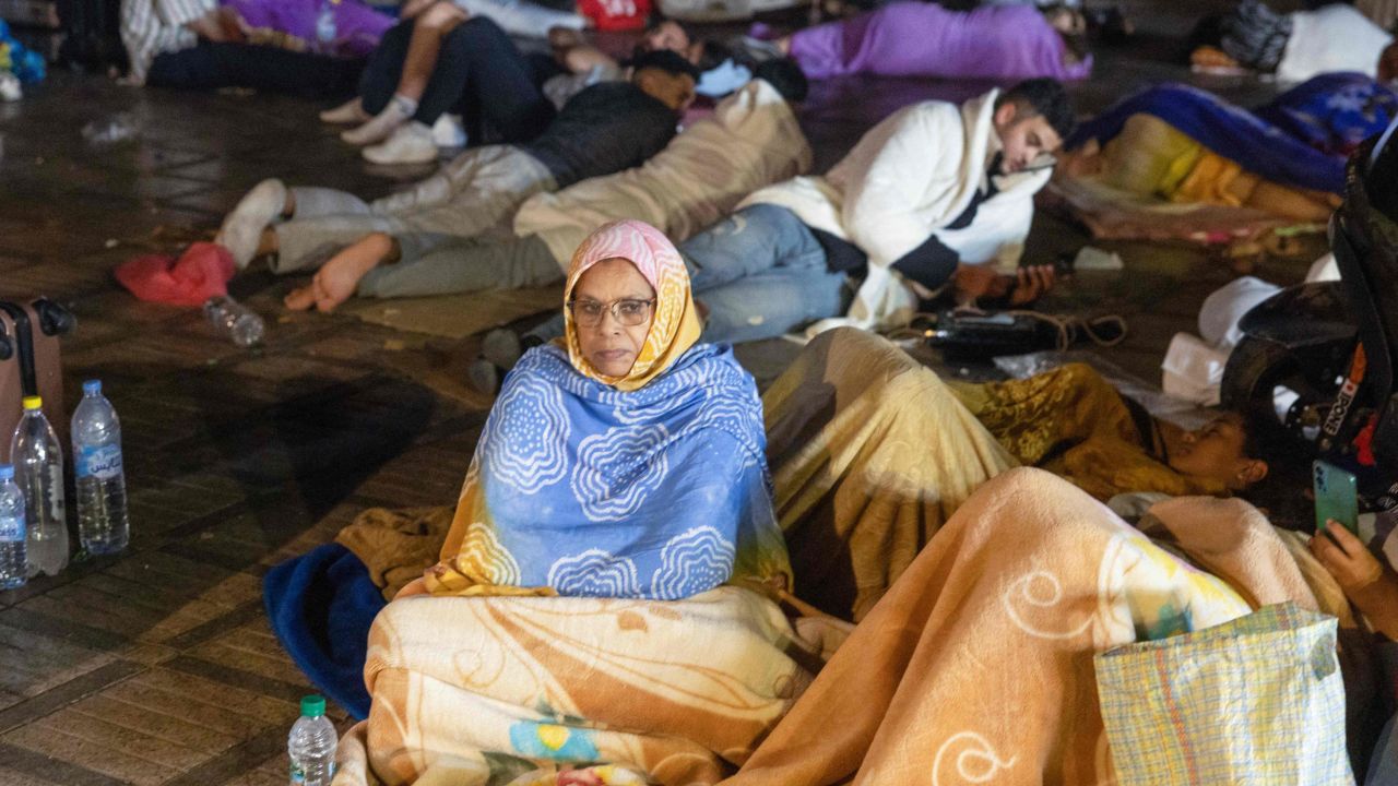 Residents take shelter outside at a square on Saturday following the earthquake.