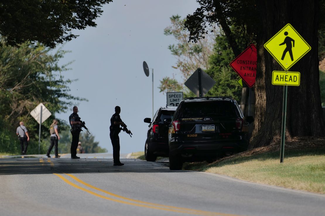 Police stand guard on the perimeter of a search zone on Friday in Kennett Square, Pennsylvania. 