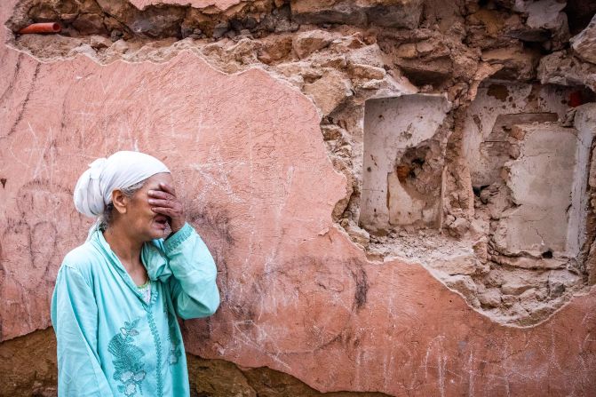A woman stands in front of her earthquake-damaged house in Marrakech on September 9. <br />