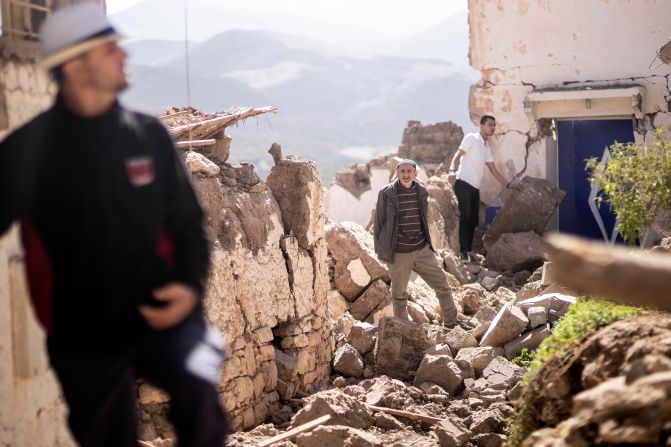 People inspect damaged homes in Moulay Brahim on September 9.