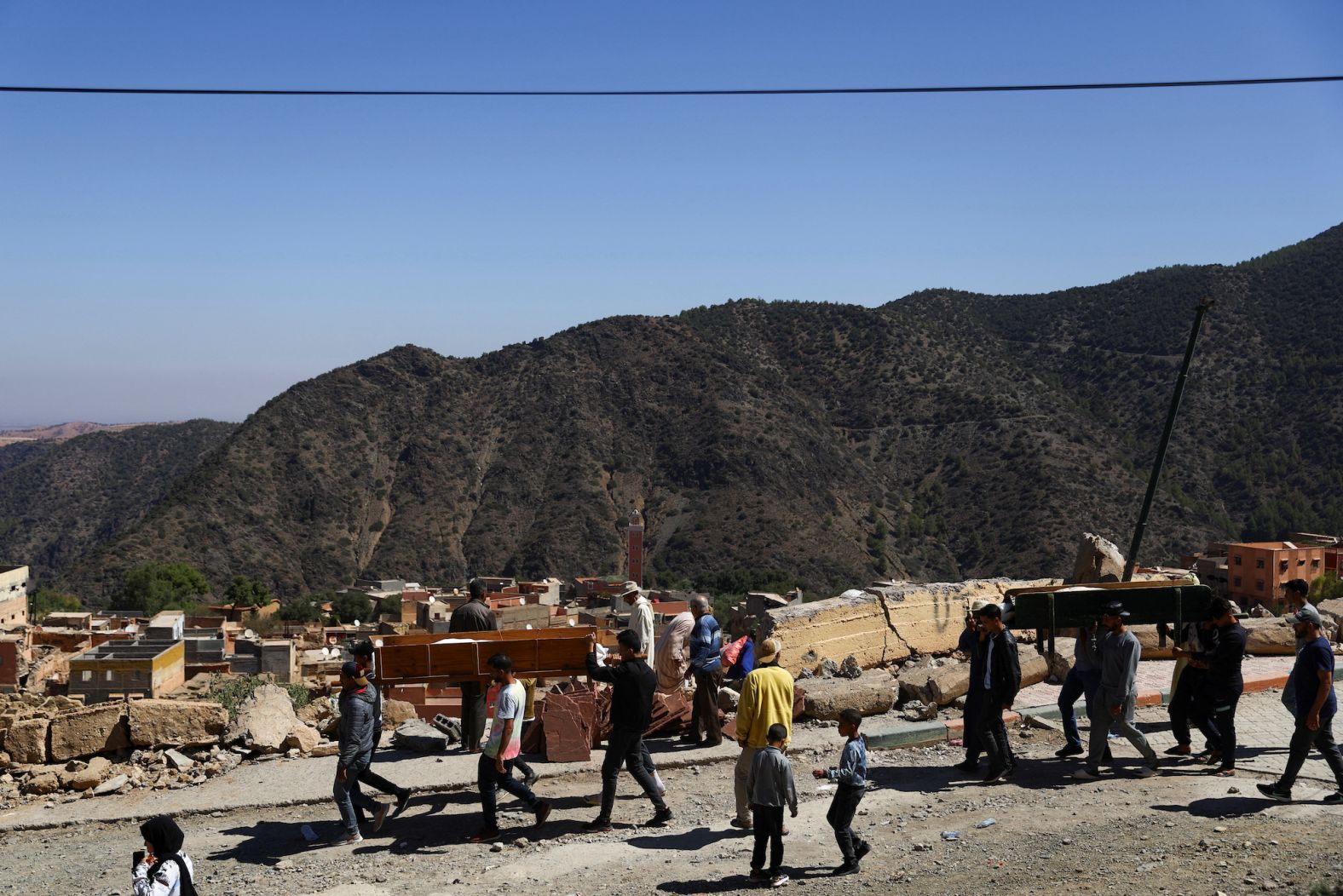 People attend the funeral of two victims in Moulay Brahim on September 10. The mountain village and others like it were <a href="index.php?page=&url=https%3A%2F%2Fwww.cnn.com%2F2023%2F09%2F11%2Fafrica%2Fgallery%2Fmorocco-earthquake-photographer%2Findex.html" target="_blank">severely impacted by the earthquake</a>, and their location has made it difficult to deliver aid.