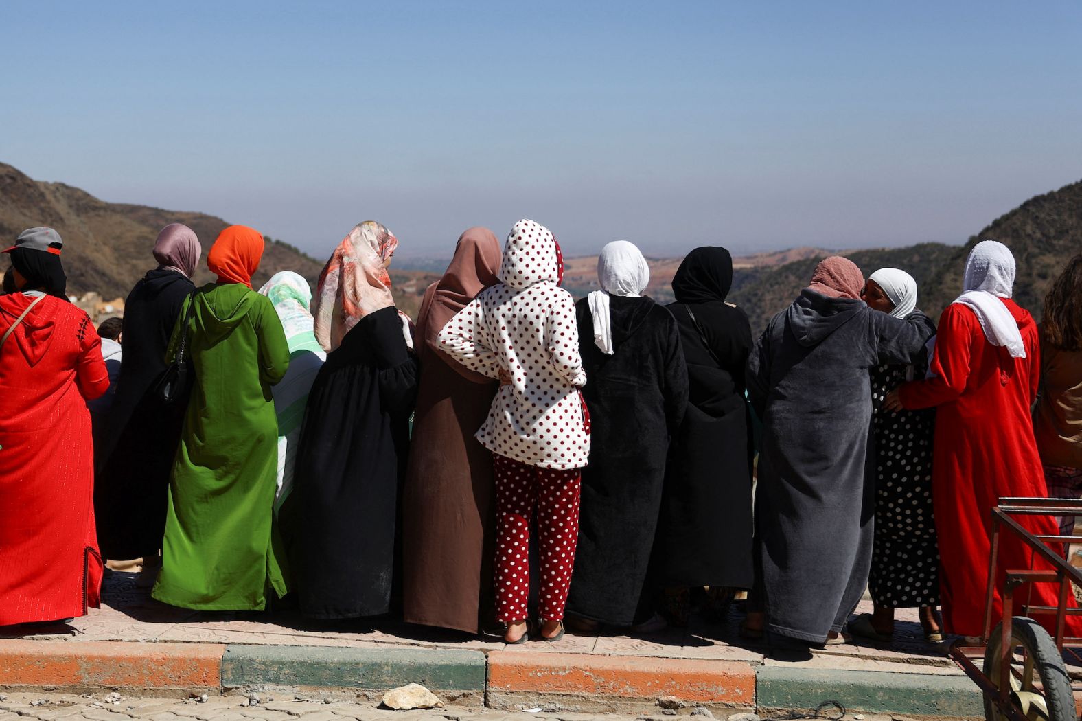 Women watch the funeral of two victims in Moulay Brahim on September 10.