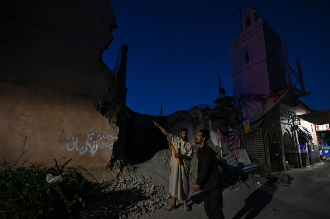 People inspect collapsed buildings in Marrakech on September 10.