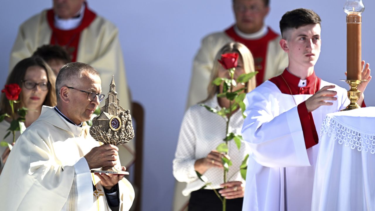 A priest brings to the altar relics of the Polish Ulma family during beatification Mass for the family, including small children, who were killed by the Nazis in 1944 for sheltering Jews.
