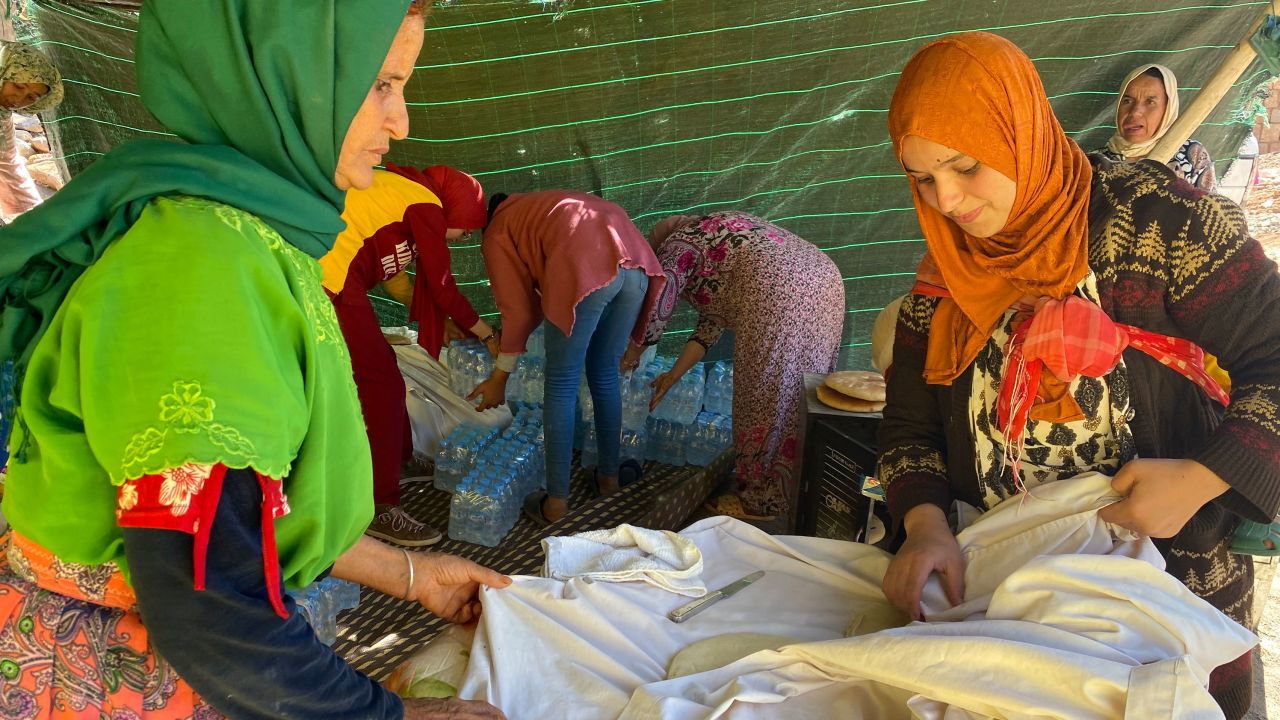 Leila Idabdelah (R) makes bread for her neighbors in a tent near her destroyed village on Sunday, September 10.