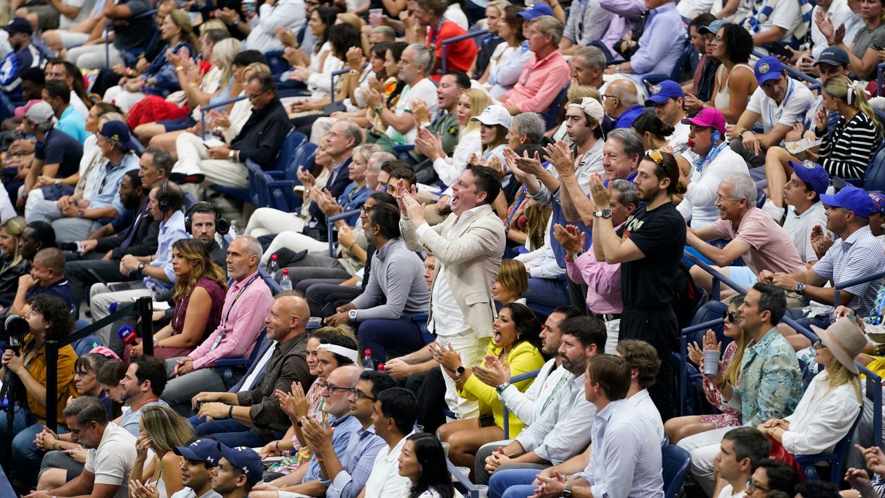 Fans cheer during the men's singles final of the US Open tennis championships.