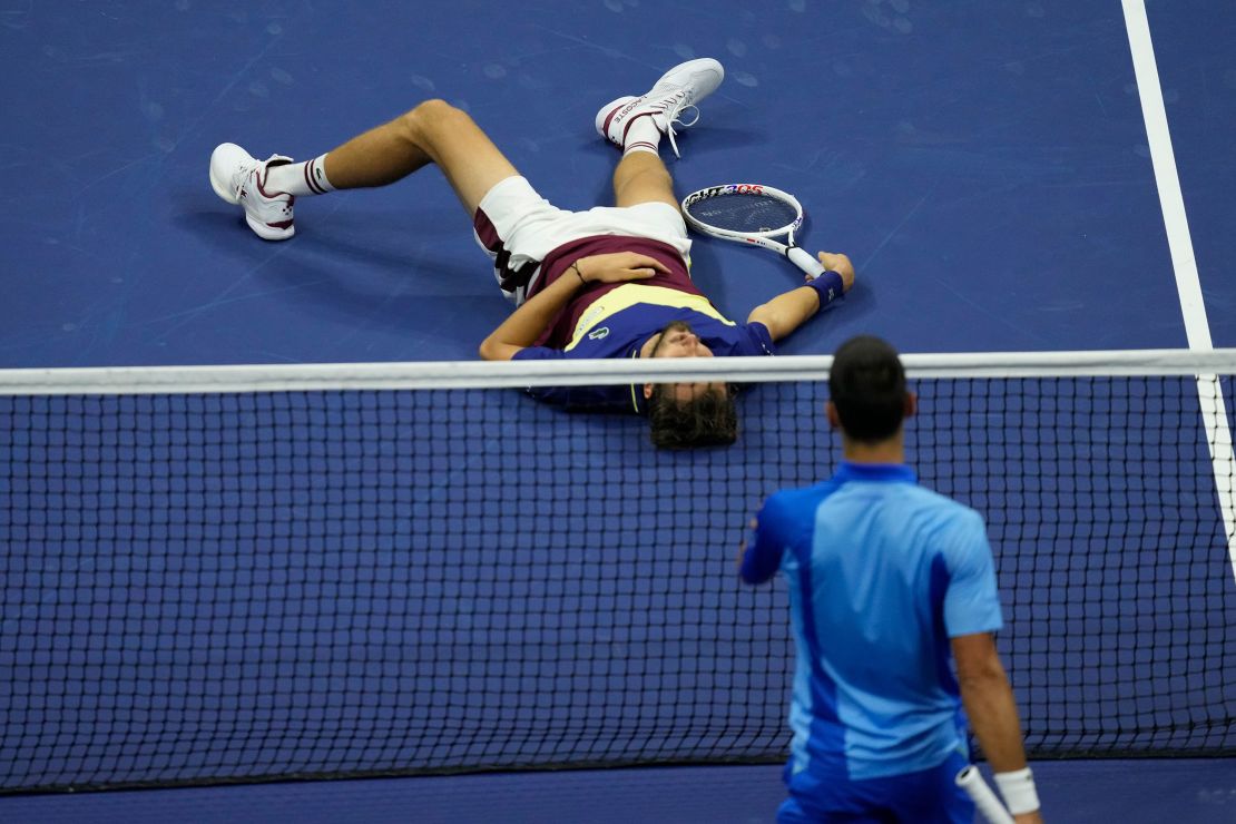 Novak Djokovic, of Serbia, moves to check on Daniil Medvedev, of Russia, who laid on the court after a rally during the men's singles final of the U.S. Open tennis championships, Sunday, Sept. 10, 2023, in New York. (AP Photo/Mary Altaffer)